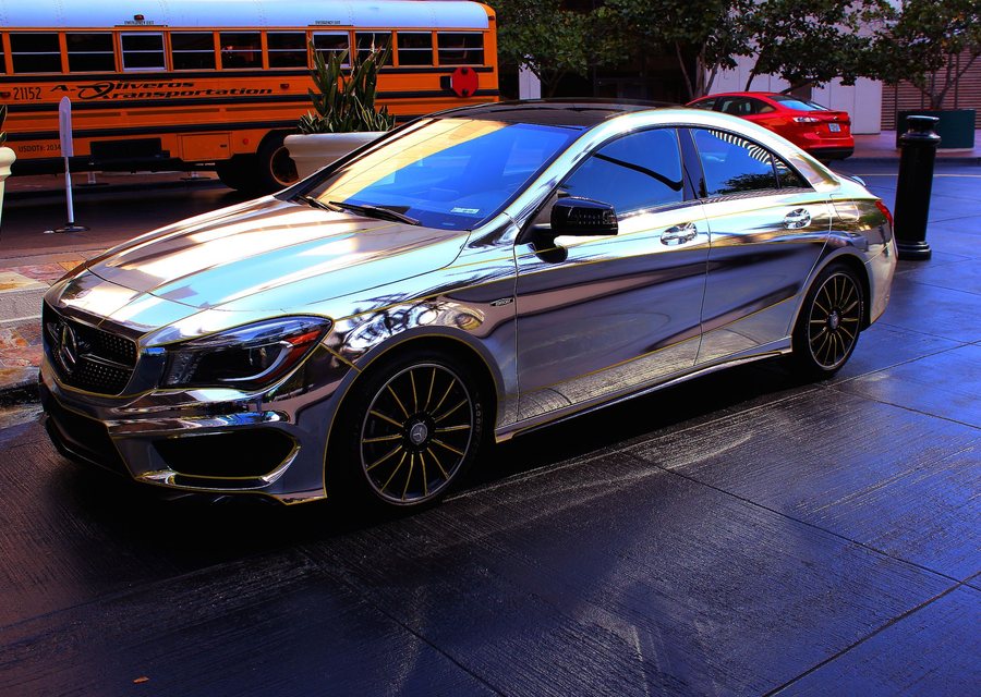 Mirror-chrome wrapped saloon reflecting the street around it
