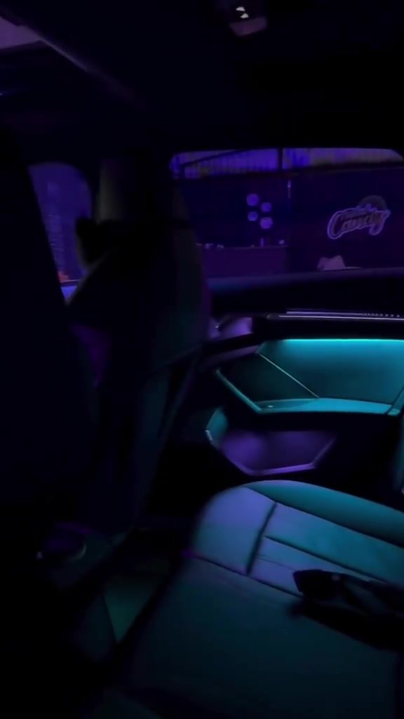 Cabin lit in teal showing the door and seat wash