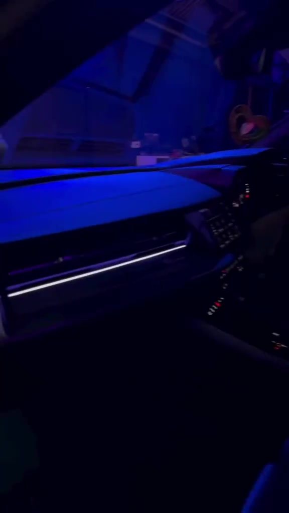 Dashboard ambient strip running the full width of the cabin in blue