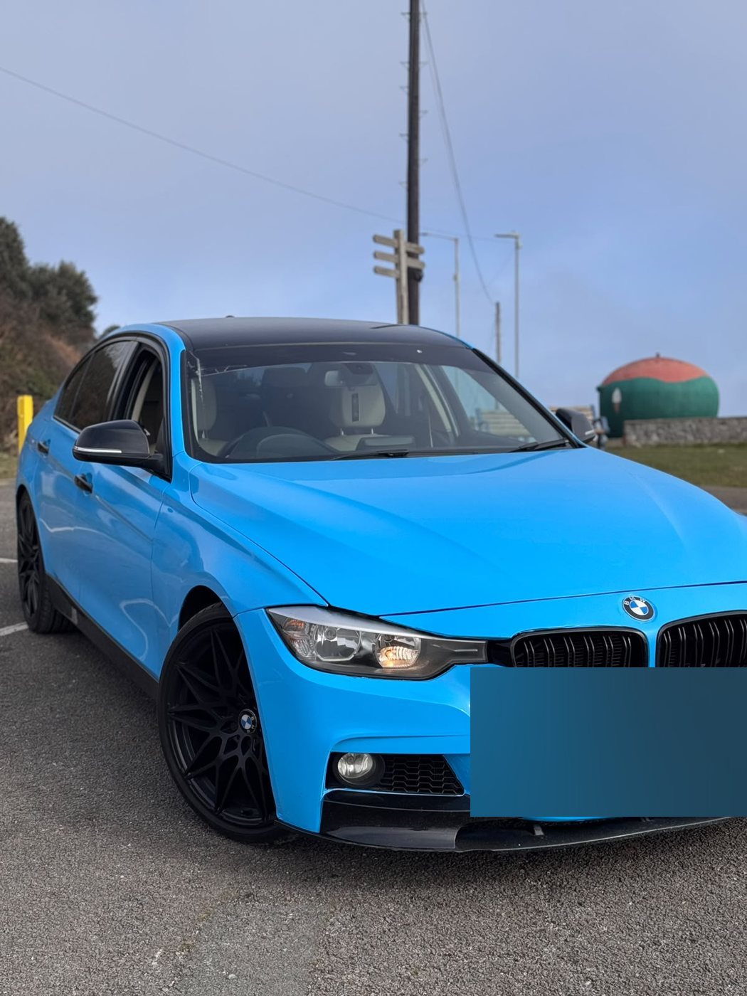 BMW 3 Series wrapped in gloss light blue with a gloss black roof