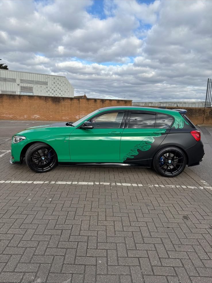 BMW 1 Series in gloss green with a matte black rear quarter and flame graphics